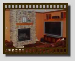 Finished basement with a fireplace.